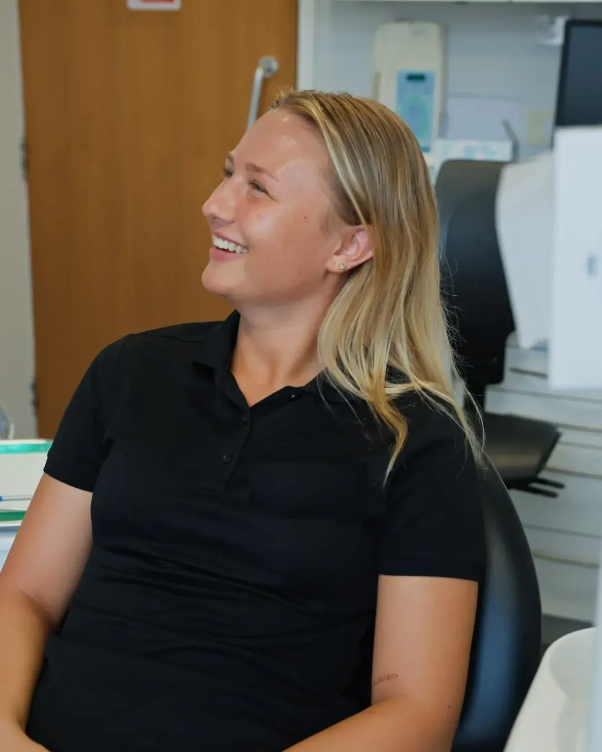 A relaxed patient laughing in the chair at Sale Dental Spa